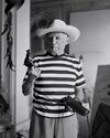 Pablo Picasso carrying a revolver loaded with blanks, which he used to shoot at people who ask...jpg