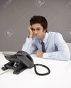 26391653-businessman-sitting-beside-telephone-waiting-for-phone-call.jpg