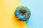 blue-yellow-glaze-donut-on-blue-yellow-paper-photo (1) (1).JPG