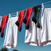 Clothes line with red and black long afl socks hanging and white shorts .jpeg