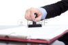 11503795-hand-with-the-seal-stamping-the-contract-close-up.jpg