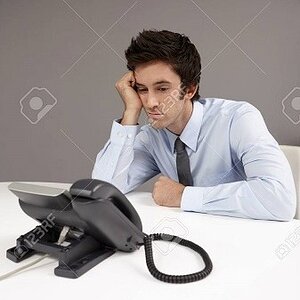 26391653-businessman-sitting-beside-telephone-waiting-for-phone-call.jpg