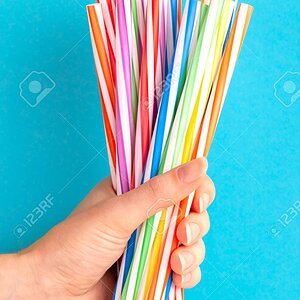 112694965-woman-is-holding-colorful-plastic-straws-in-hand-on-bright-background-event-and-part...jpg