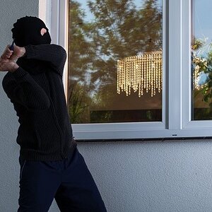 window-protection-burglar-breaking-window.jpg